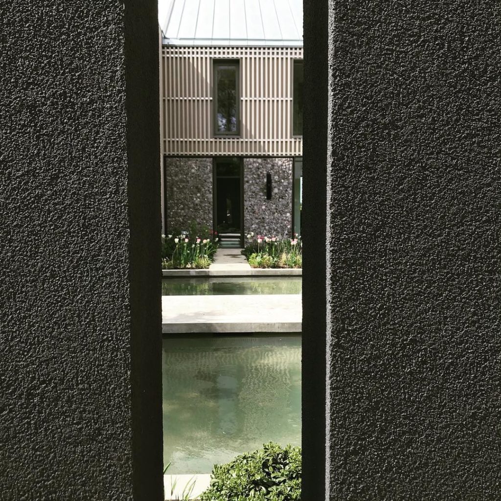 A glimpse of the #courtyard through a slit in the wall. #water #tulips large #la...