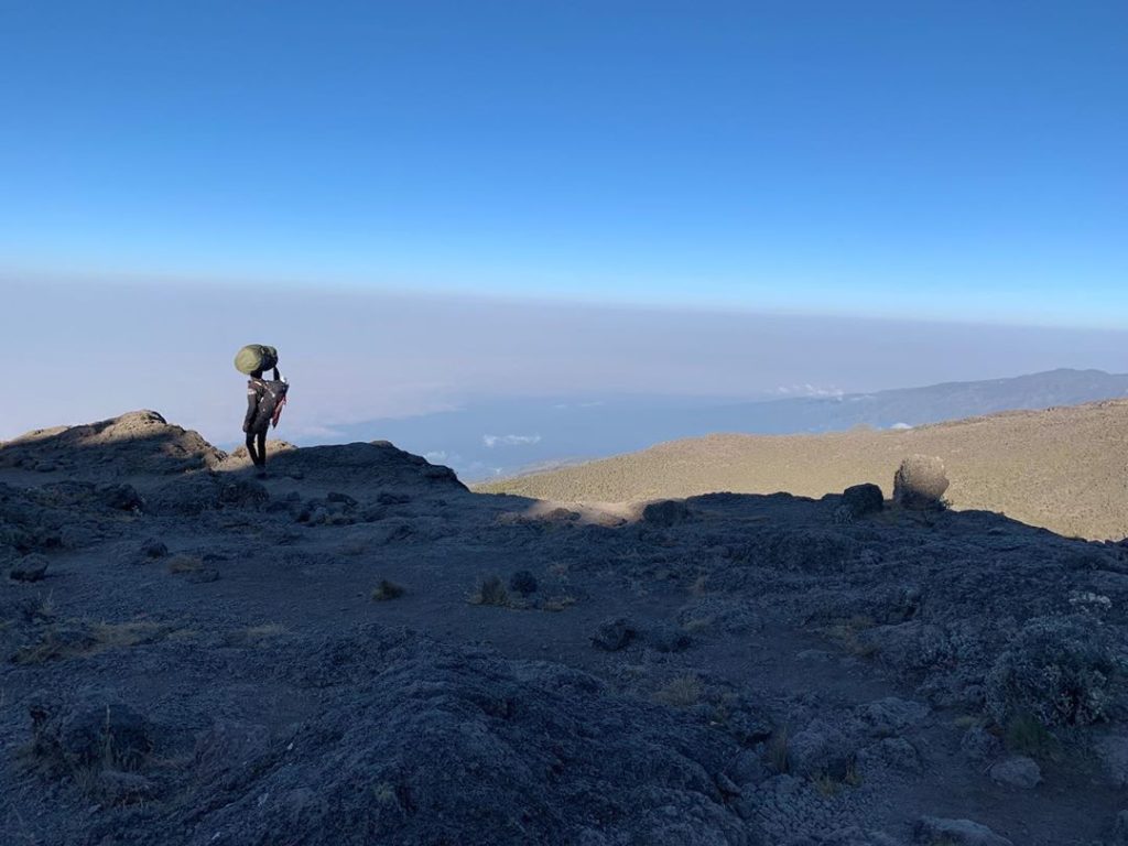 kategouldgardens: A lone Kilimanjaro porter takes in the stunning views from the mountain.
.
There… A lone Kilimanjaro porter takes in the stunning views from the mountain.
.
There...