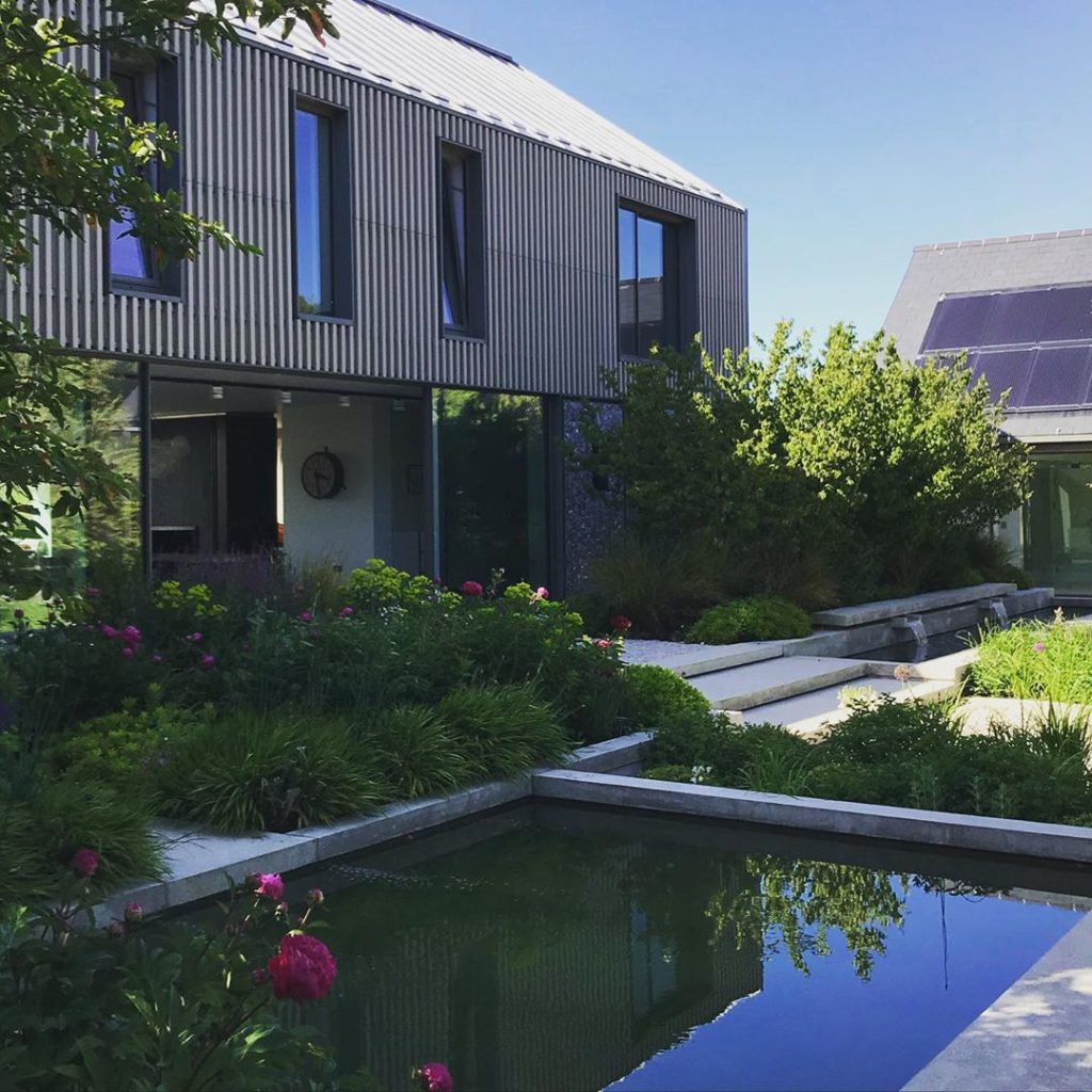 Deep burgundy #peonies reflecting on the large water bassin in this large enclos...