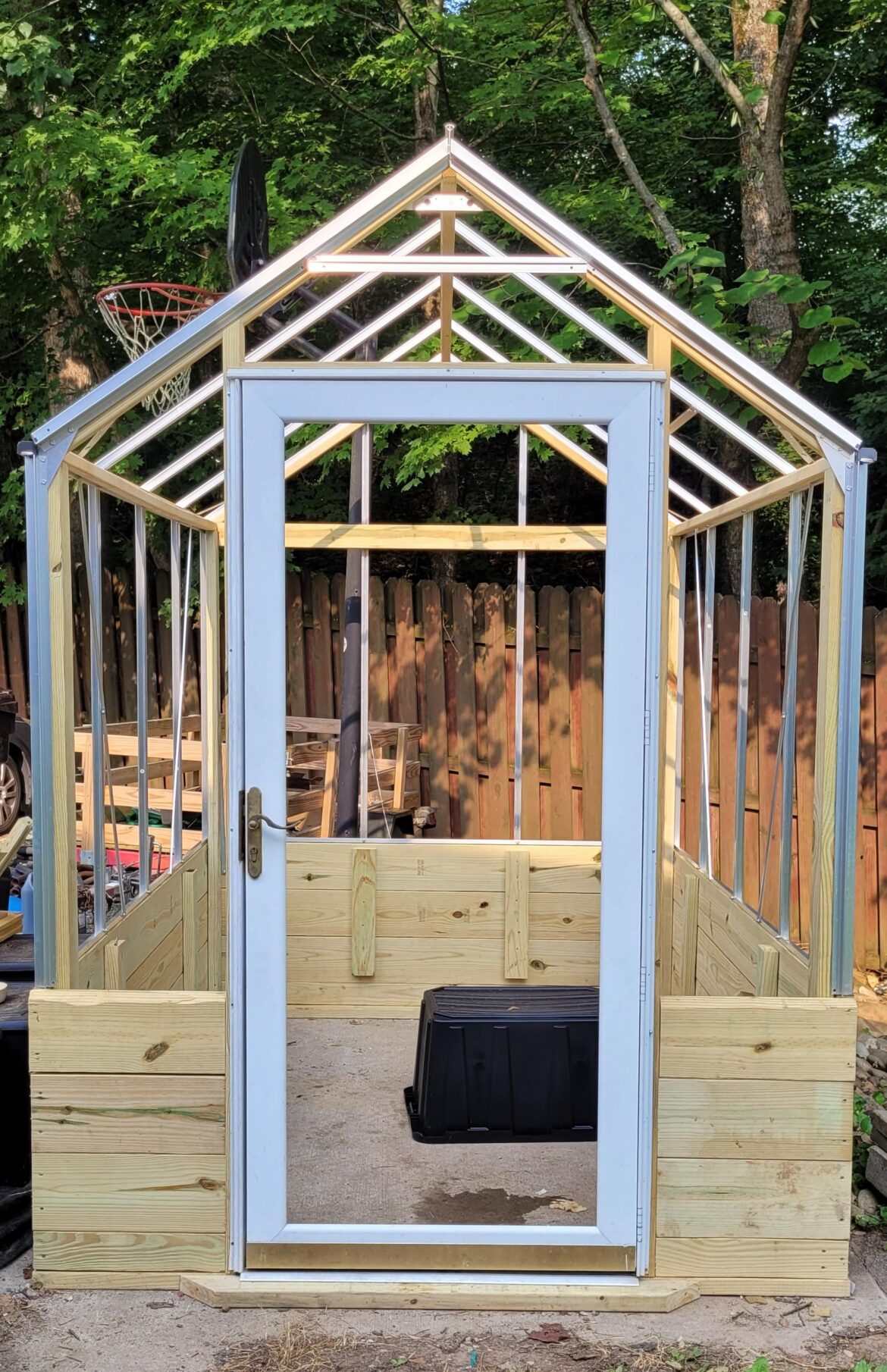 My greenhouse is closer to being done, I just finished installing the door!