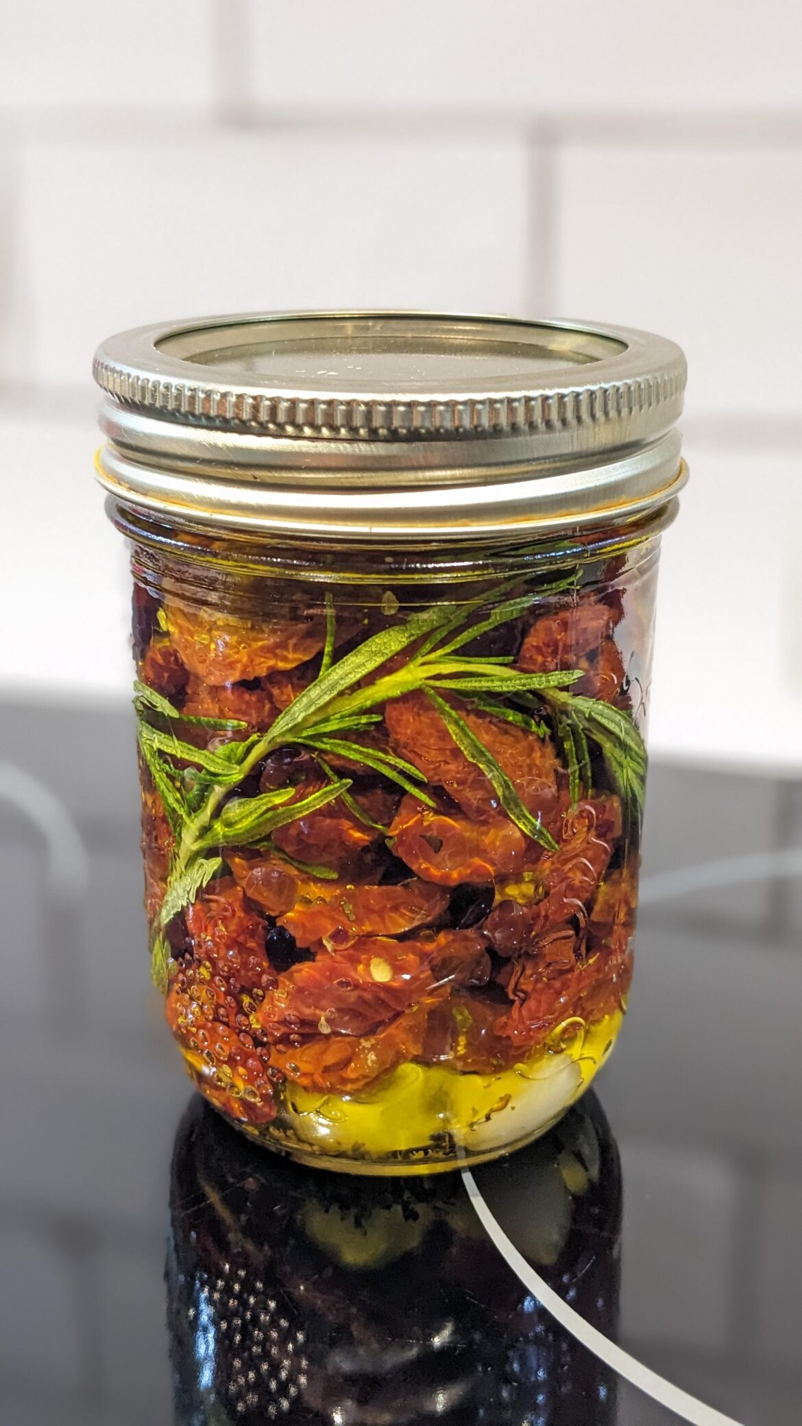 Every year, I can't keep up with the cherry tomatoes. This year, decided to try the "sundried and canned" option.