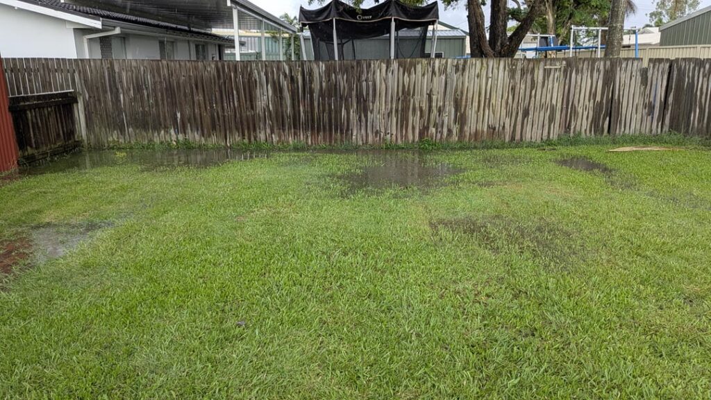 How do I fix this wavy lawn that doesn't drain well?