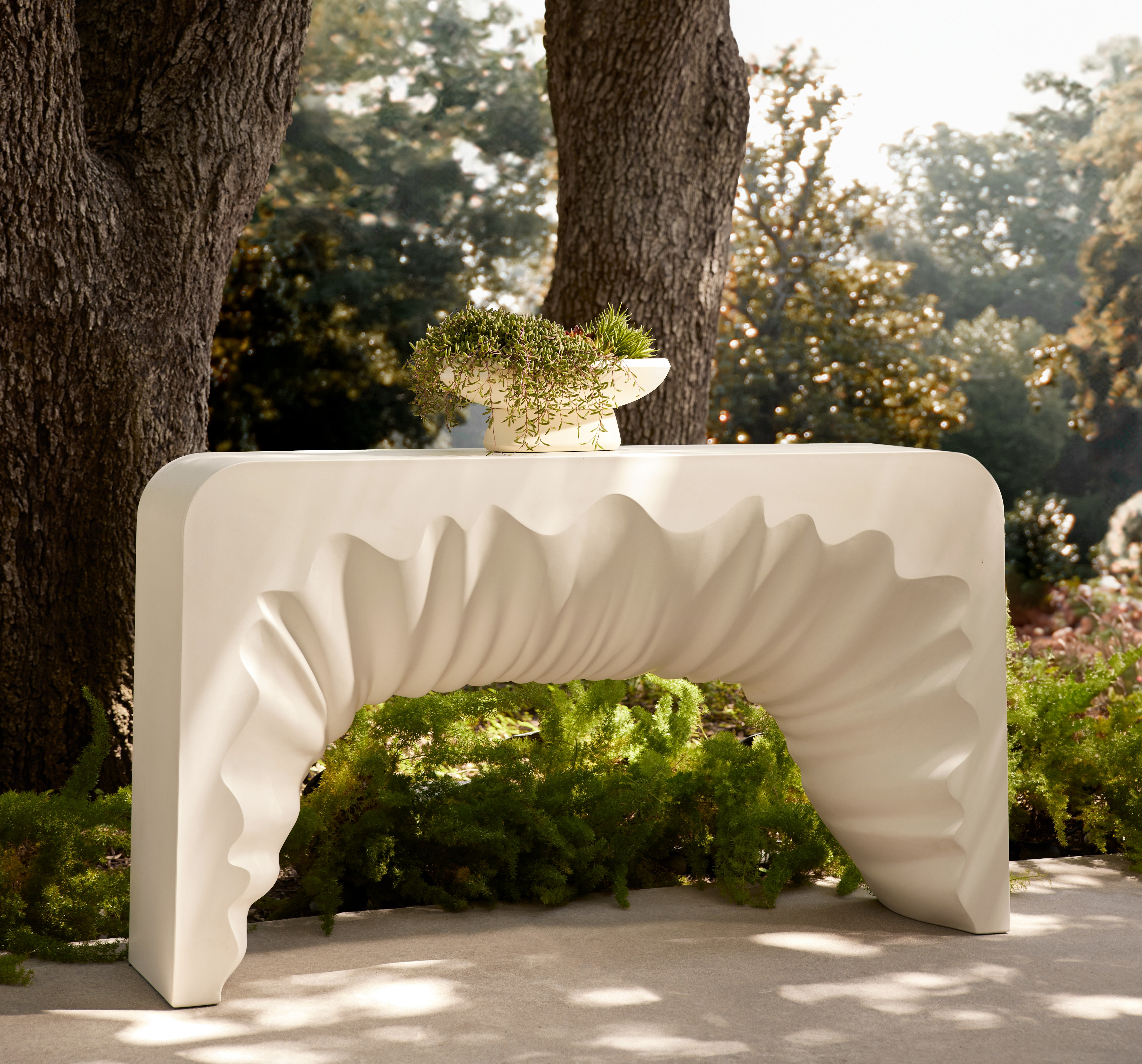 White outdoor console table with a draped design.