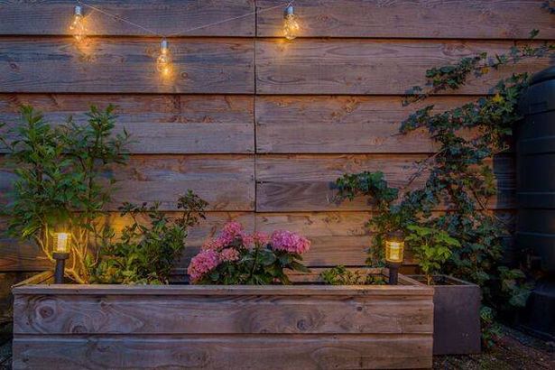 Garden lighting hanging by a fence