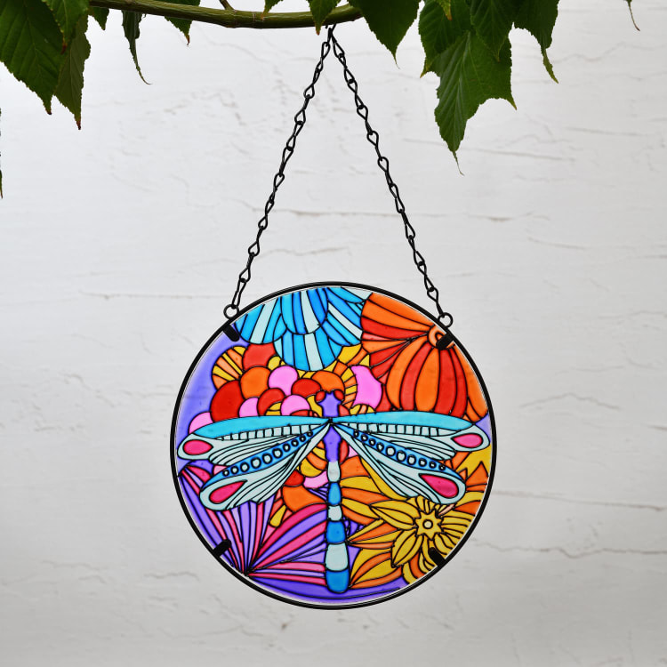 Round stained-glass hanging decoration with a dragonfly and flowers.