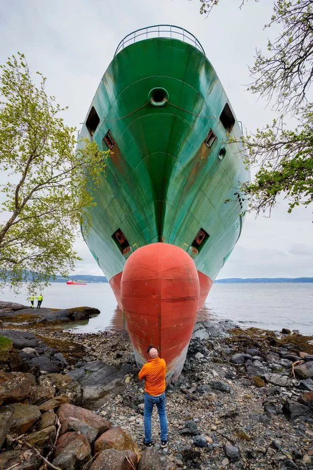 A man standing in front of the huge vessel