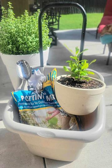 Portable Plastic Gray Garden Cart filled with supples.