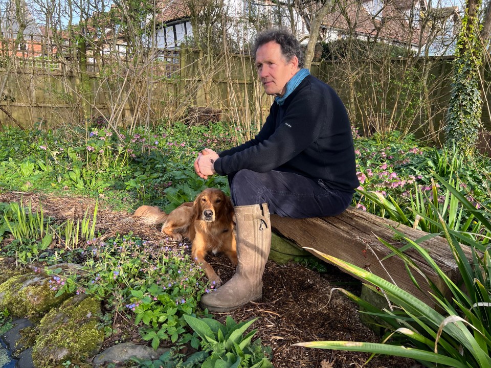 Monty Don with his dog Ned in his garden.