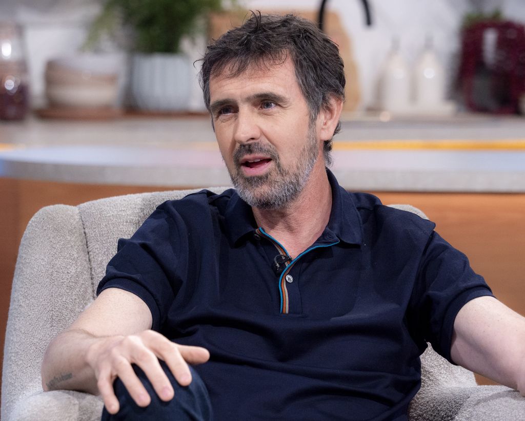 Adam Frost looking serious in a navy top while appearing on Lorraine