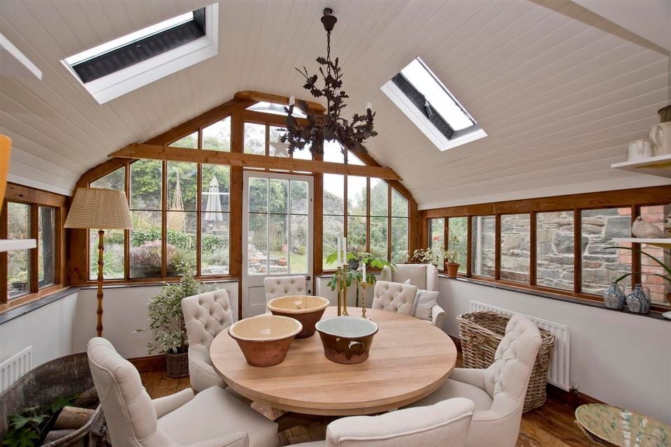 The windows were designed and built from reclaimed pitch pine and the interior windowsills are made from slate reclaimed on site