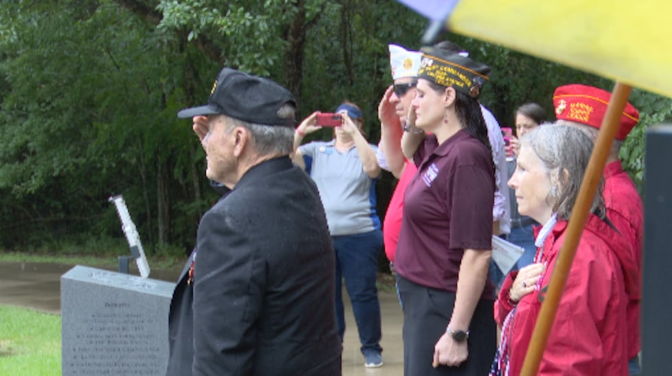 Attendees watched as a wreath was laid in honor of the service men and women who fought for...