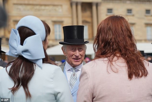 The King, looking very sharp in a hat, beamed as he spoke to attendees during the garden party today