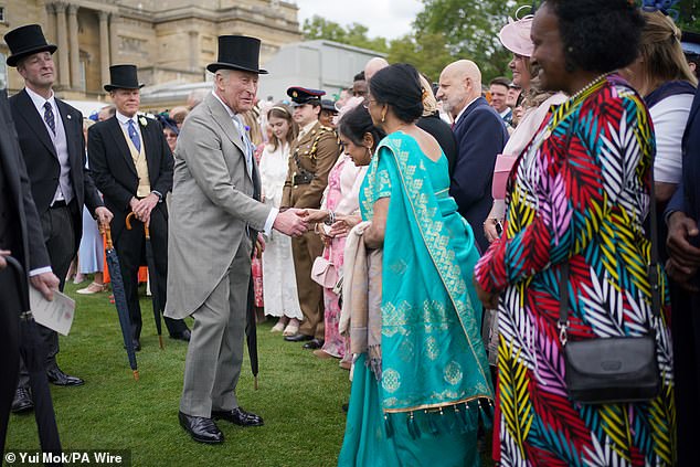 Charles was in high spirits as he greeted guests during the party at Buckingham Palace this afternoon