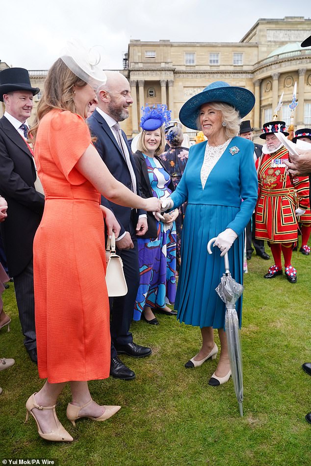 Camilla, sporting white gloves, also carried an umbrella for the unpredictable weather this afternoon