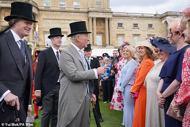 Charles, smiling, was animated as he chatted with the respected guests in attendance at the event
