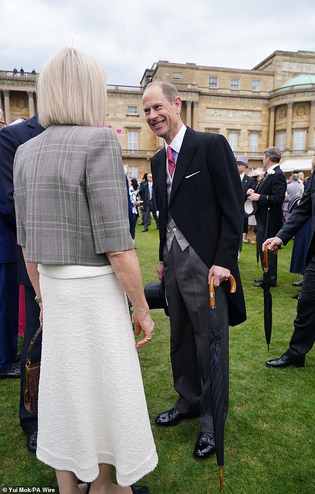 Prince Edward, pictured, also held onto an umbrella as he joined his brother for the garden party
