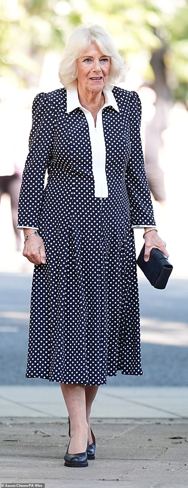The Queen looked regal as she stepped out in an elegant polka dot monochrome Fiona Clare couture maxi dress, along with comfortable black heels and a matching clutch bag