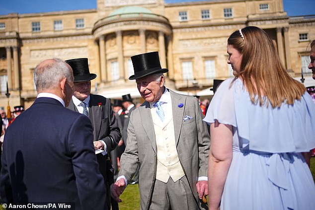 King Charles (pictured, centre) greets members of the public at the Education and Skills Garden Party