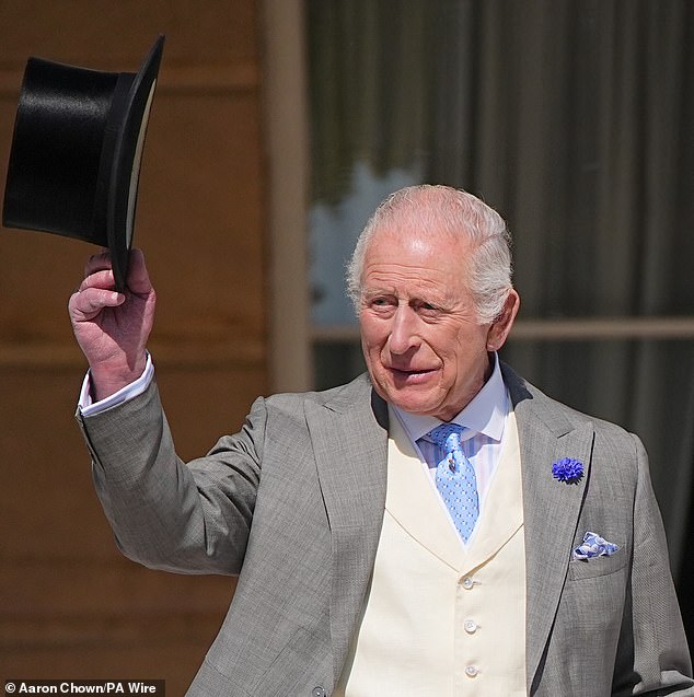 The King was pictured tipping his top hat as he arrived at the garden party on Wednesday afternoon