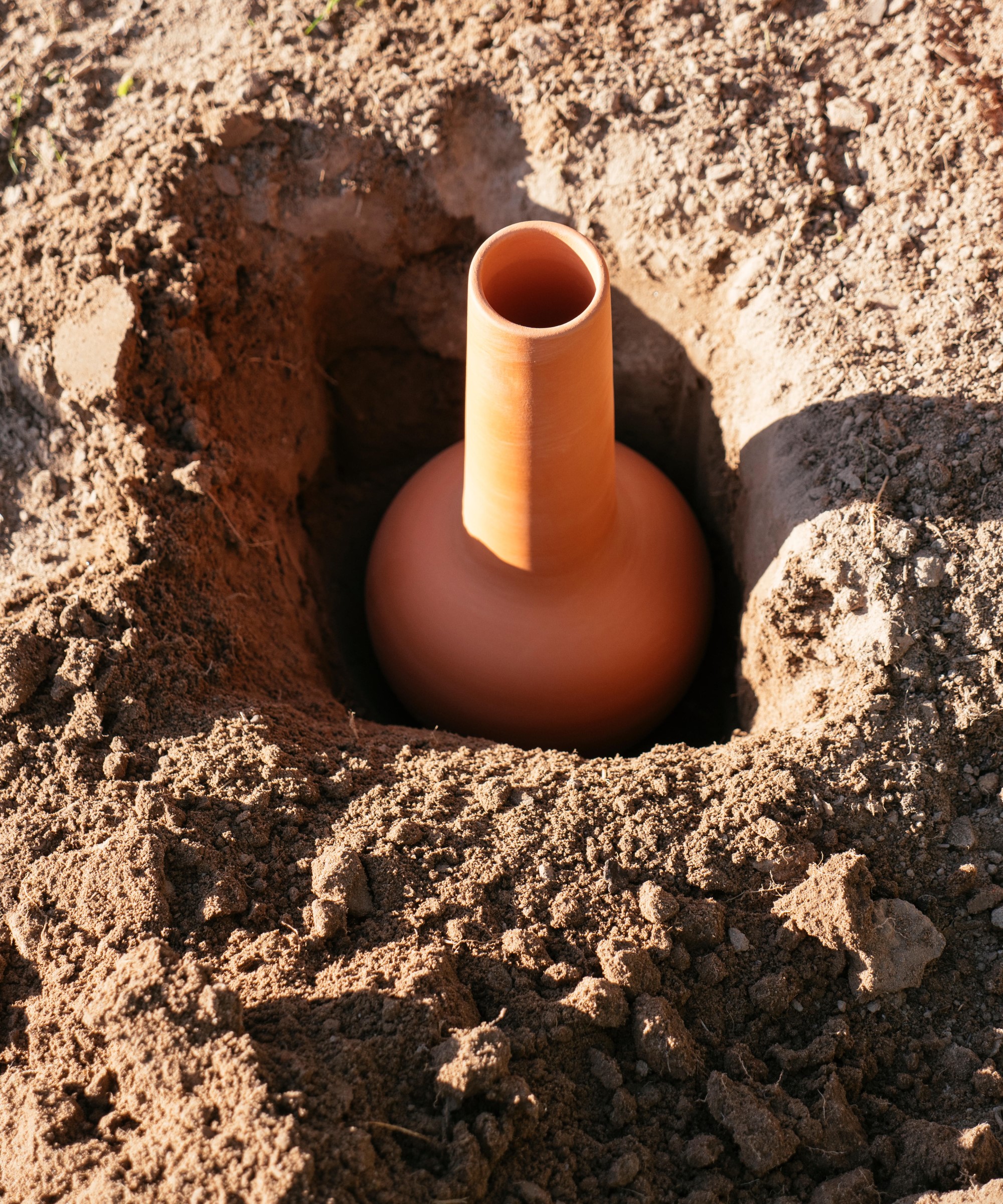 An olla buried in soil