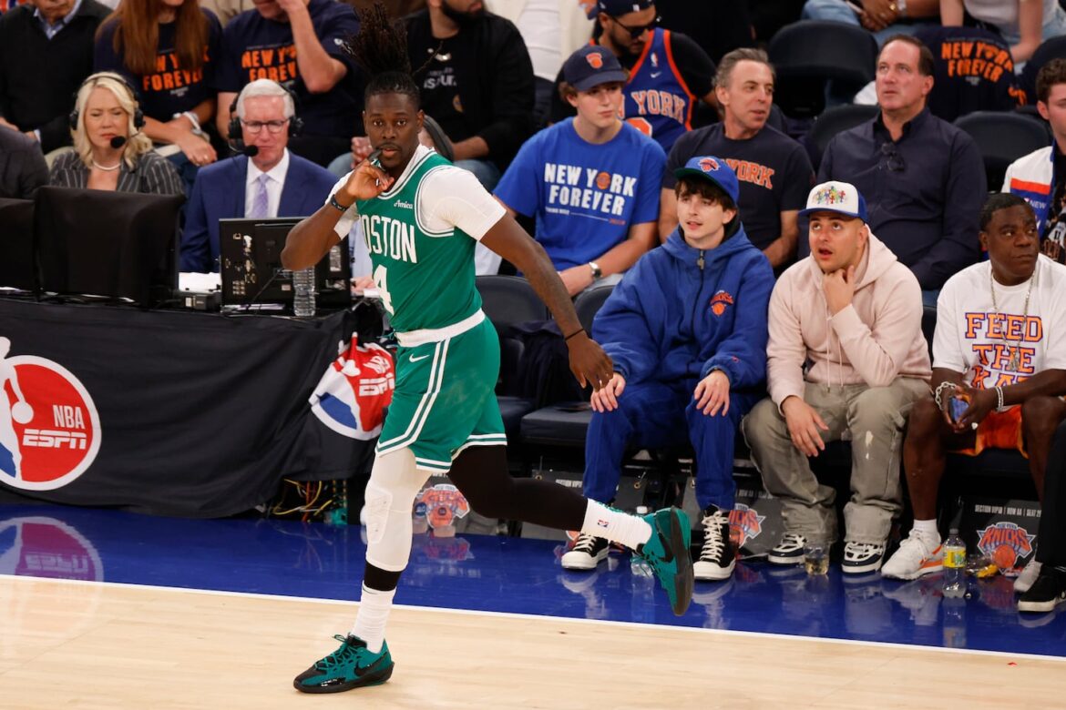 Jrue Holiday celebrates in front of actor Timothée Chalamet at Madison Square Garden.