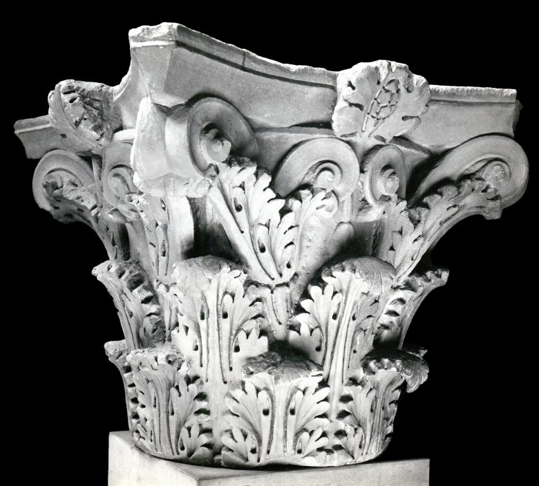 Photo of a marble Corinthian capital carved with Acanthus leaves as decoration.