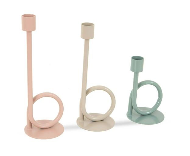 Three pastel-colored metal candle holders with handles.