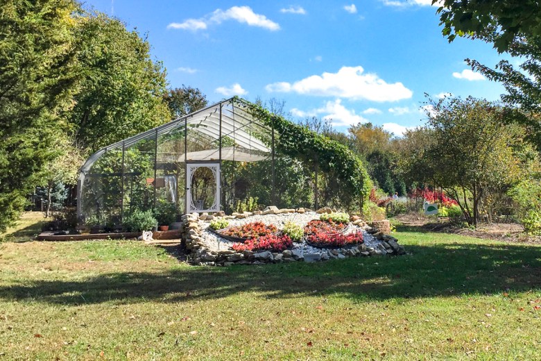 An exterior photo of a butterfly house in a park