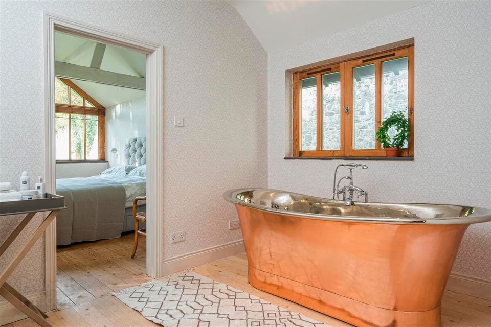 It has five bedrooms including master with bathroom and dressing room with copper free-standing bath