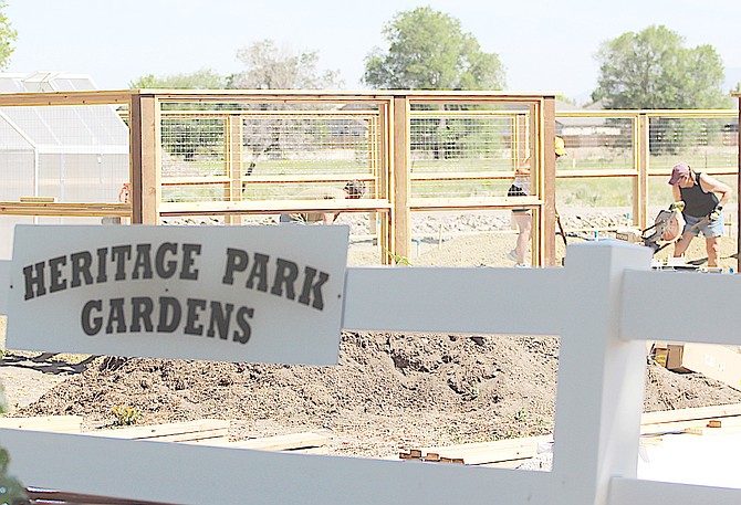 Volunteers work on the planting beds at Heritage Park Gardens on Thursday morning in Gardnerville in preparation for Saturday's plant sale and open house.