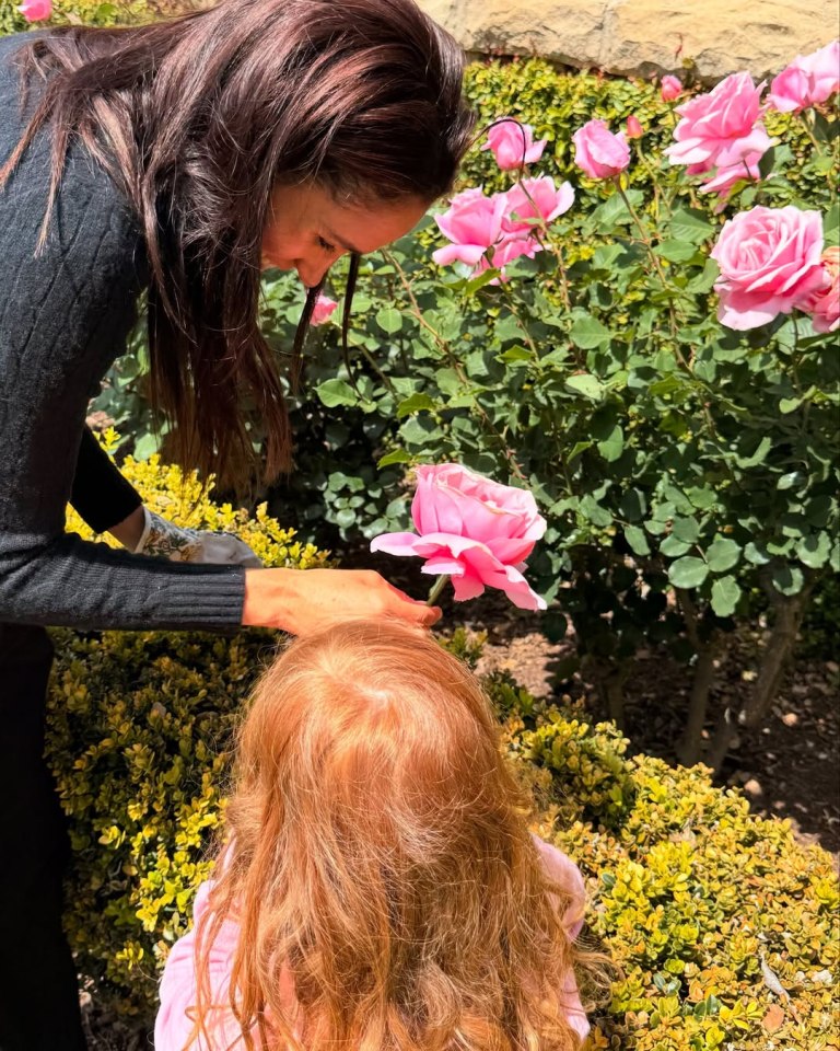Meghan Markle with her daughter Lilibet and pink roses.