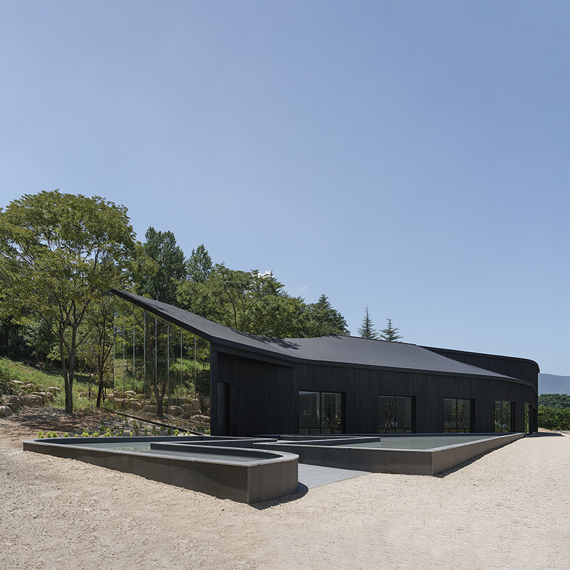 mirrored facades of 'tan-mok-won' korean bakery dissolve into healing landscape