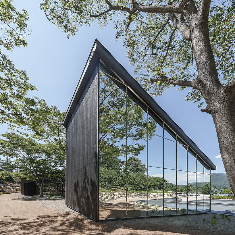 mirrored facades of 'tan-mok-won' korean bakery dissolve into healing landscape