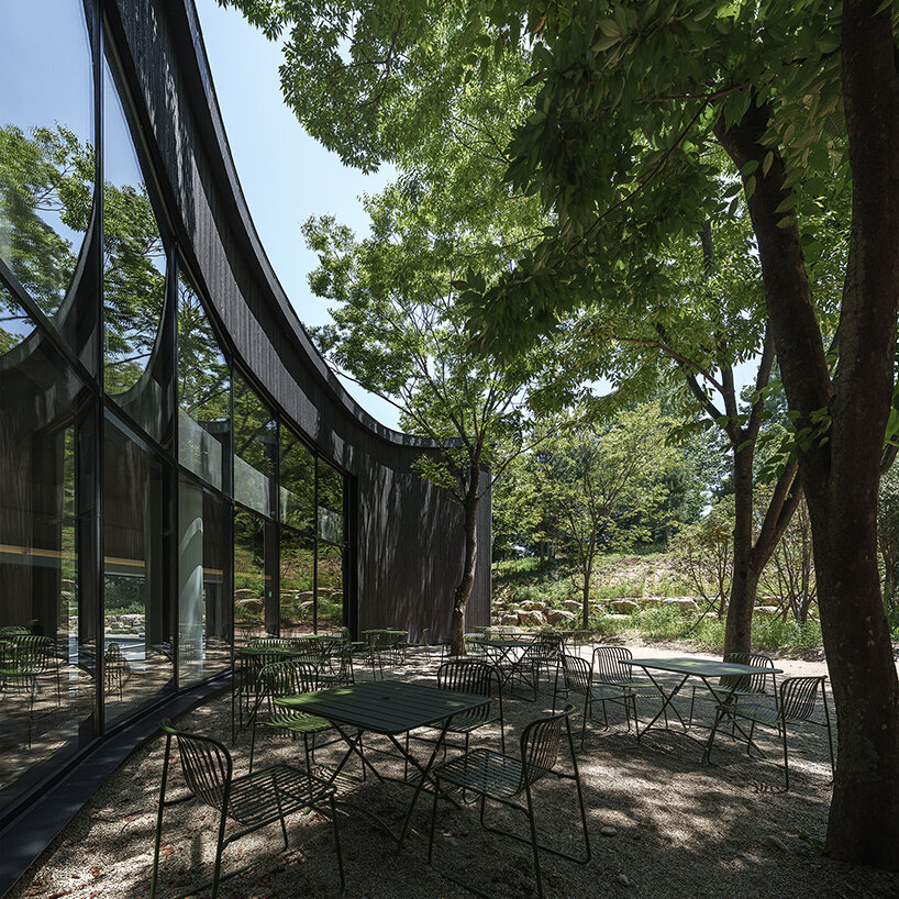 mirrored facades of 'tan-mok-won' korean bakery dissolve into healing landscape