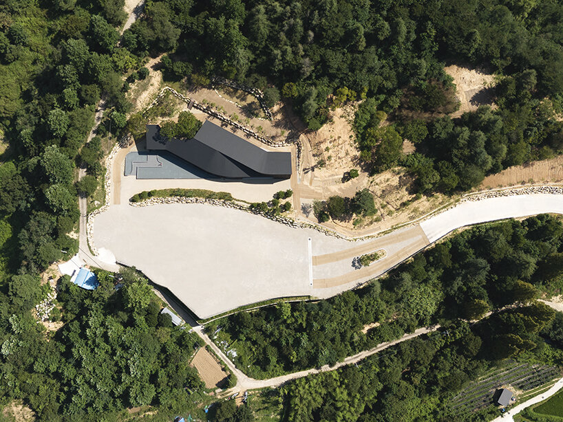 mirrored facades of 'tan-mok-won' korean bakery dissolve into healing landscape