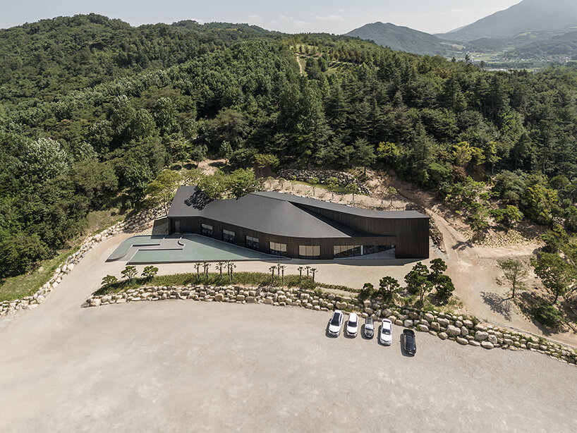 mirrored facades of 'tan-mok-won' korean bakery dissolve into healing landscape