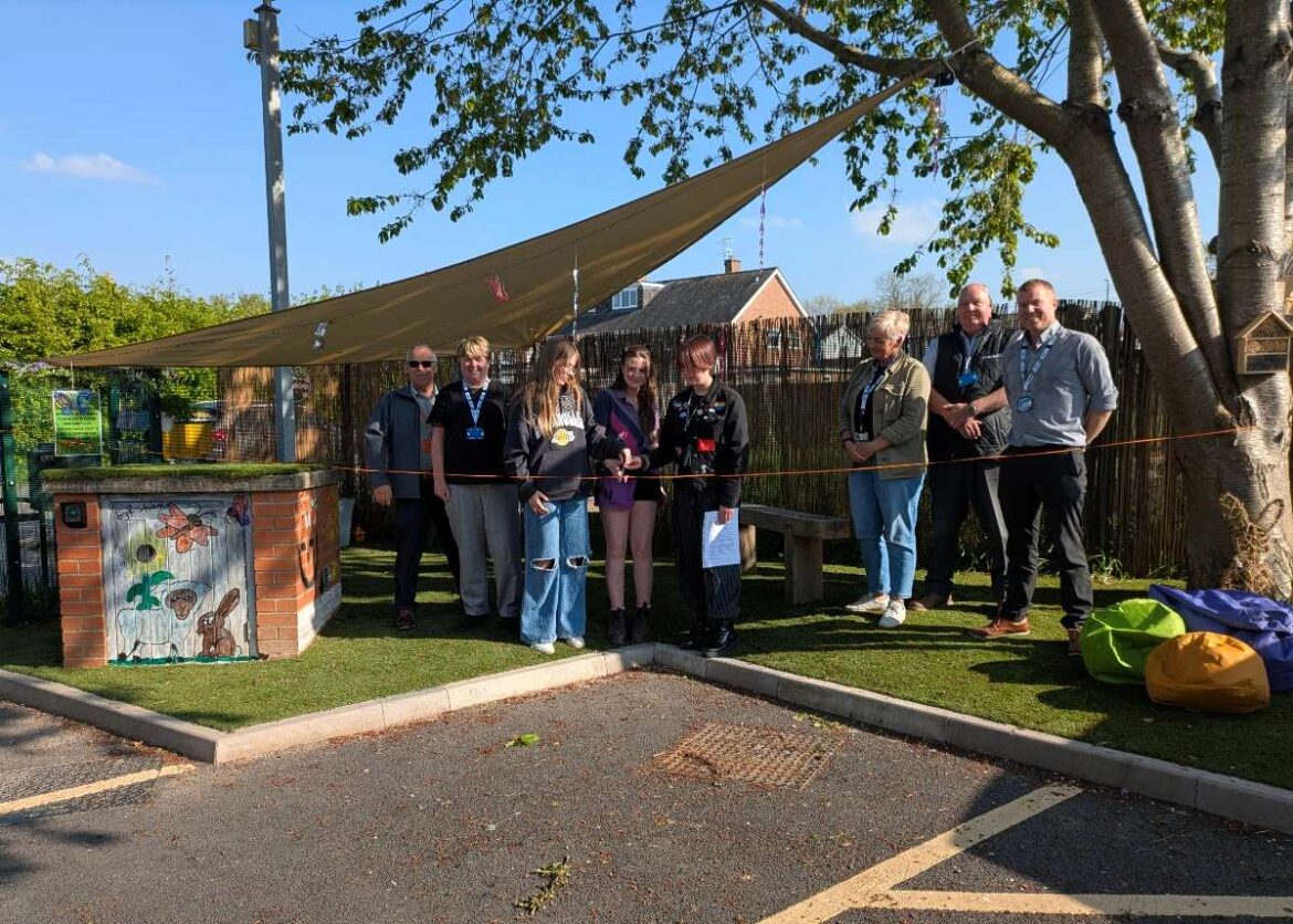 Youth charity gets new sensory garden thanks to donation Staff from Homes Plus and SYA with members of the youth forum opening the garden