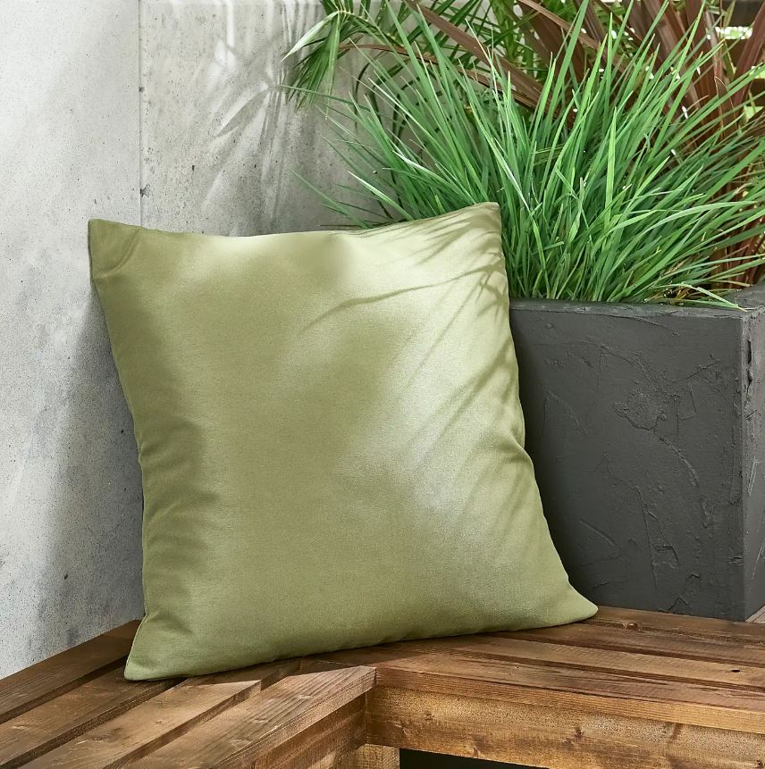 Olive green outdoor cushion on a wooden bench.