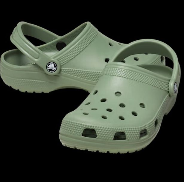 Green crocs on a black background 