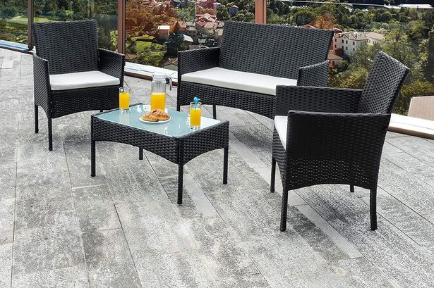 Photo shows black rattan furniture set on balcony