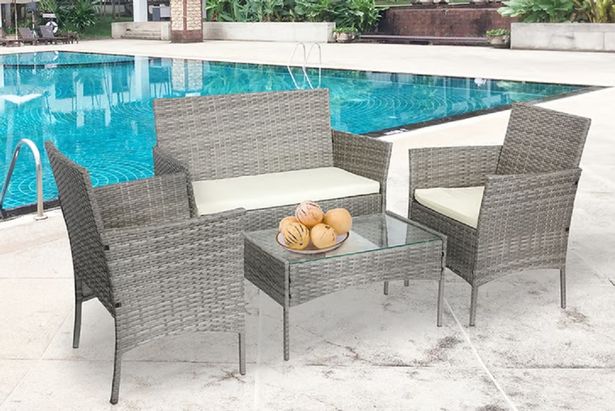 Photo shows grey rattan furniture near pool