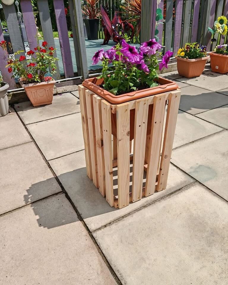 DIY pallet planter with purple flowers.