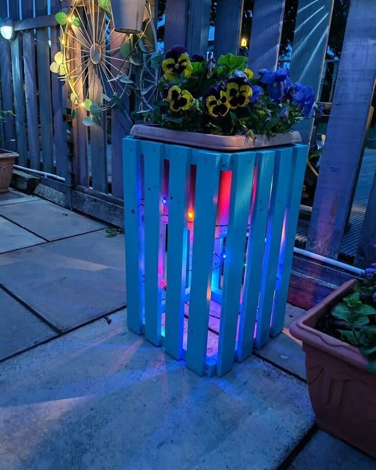 DIY illuminated planter box with flowers.