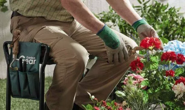 A person using the Thompson & Morgan Garden Kneeler & Seat while gardening