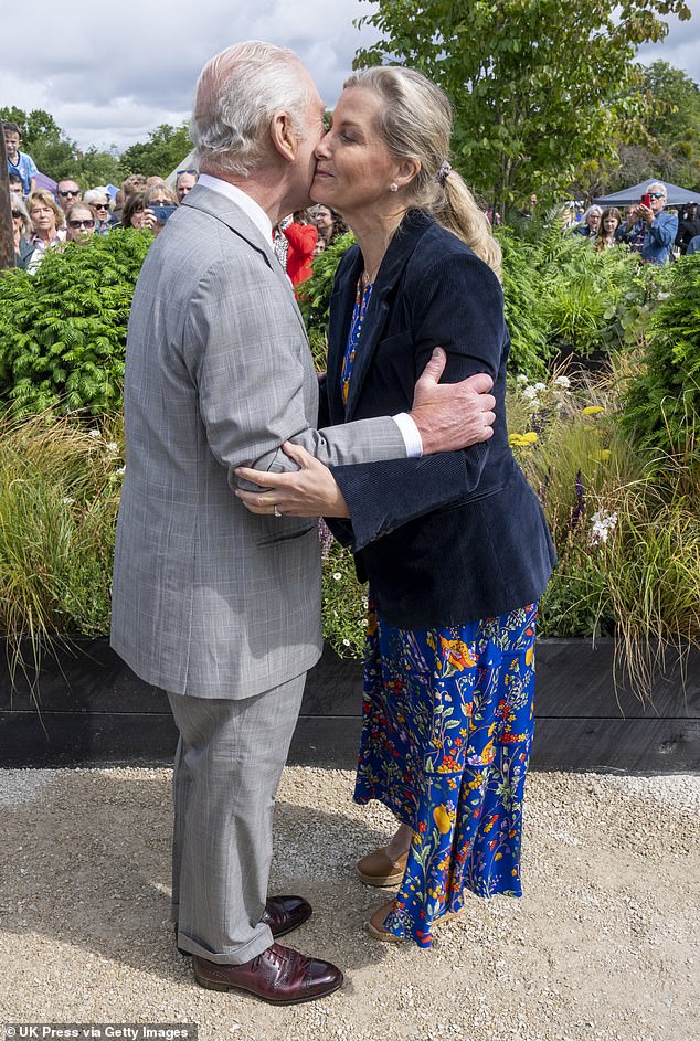 Chuckling in front of the cameras, our exclusive pictures show the Duchess kissing her brother-in-law the King on the cheek, followed by a quick curtsy which made her almost lose her balance