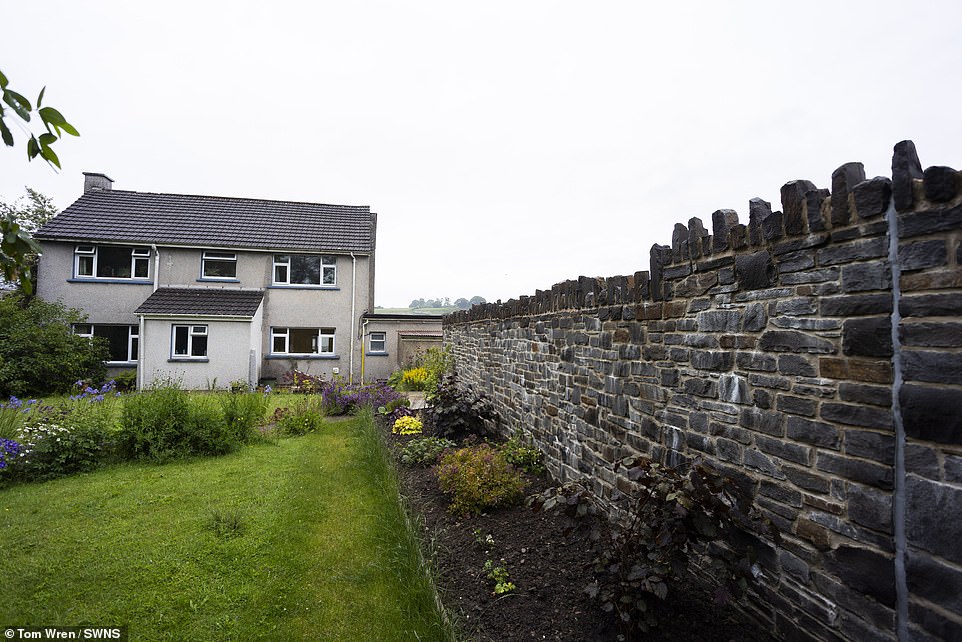 The 28-mile road now snakes round Mr Watkey's house not through it and he's left with a massive wall at the end of his garden - which he has started to replant