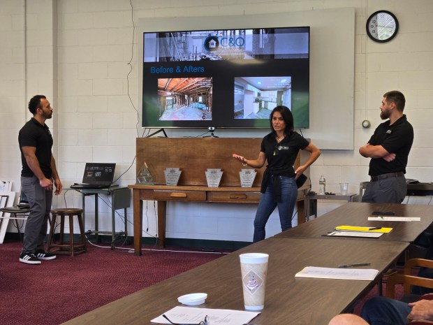 Erica Stuart, whose parents founded C&O Services, delivers a presentation to the Lower South Valley Land Bank board of directors in the conference room at Earth Conservancy in Ashley on Wednesday, with assistance from her C&O colleagues, Henry Paz, left, and Michael Mayernik, right. (STEVE MOCARSKY / STAFF PHOTO)
