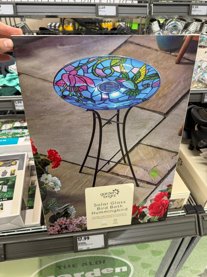 Solar-powered glass hummingbird bird bath on stand.