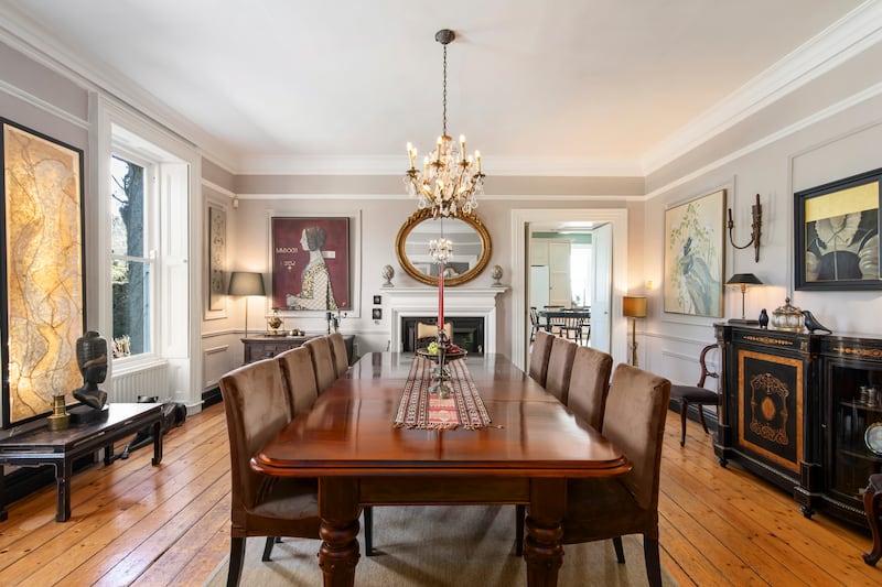 Diningroom with a piece of artwork (left of table) by former resident artist Polly Minette which comes with the house
