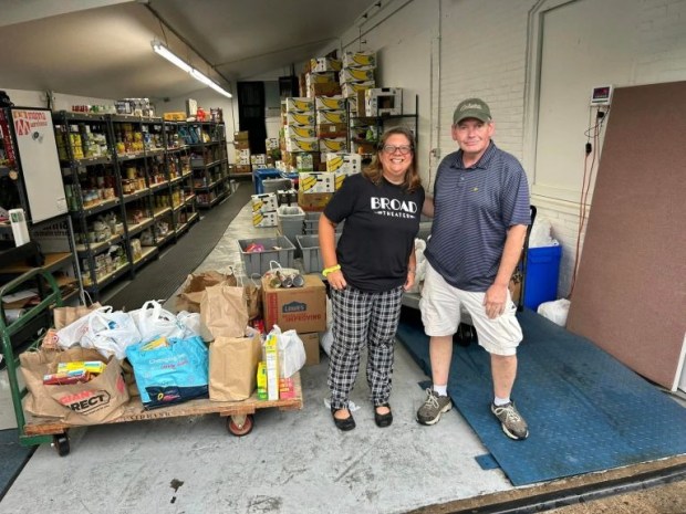 Lansdale Open Gardens Tour organizer Jenniah Caldwell, left, and Manna on Main Street Food Resources and Operations Director Jim Lynch pose with several hundred pounds of food donated by garden tour attendees in 2023. (Photo courtesy of Jenniah Caldwell)